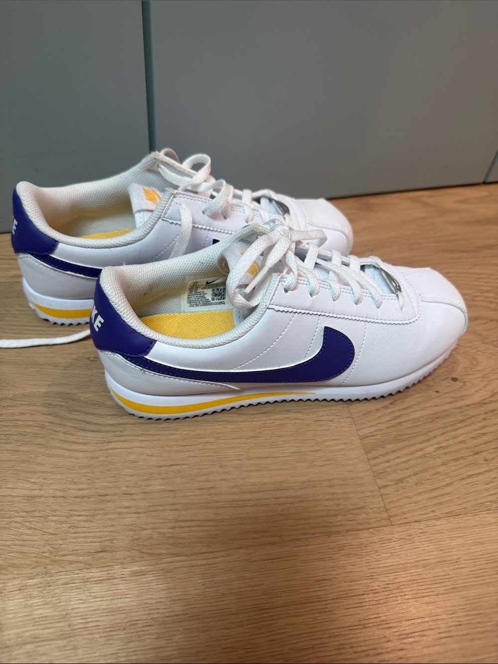 Nike White Kids Sneakers with Purple Swoosh and Yellow Trim